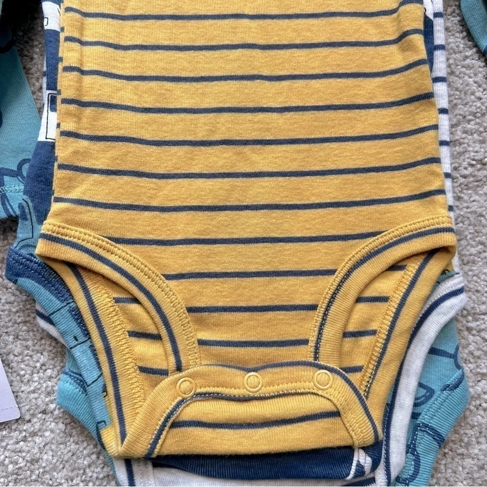 NWT Carter’s baby size 9 months four pc. Long sleeve onesies
